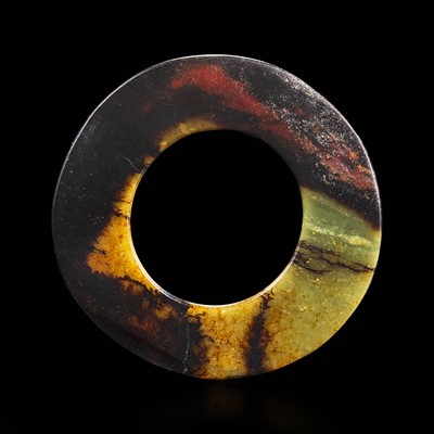 Lot 88 - A Chinese brown and celadon jade Bi disk 玉璧