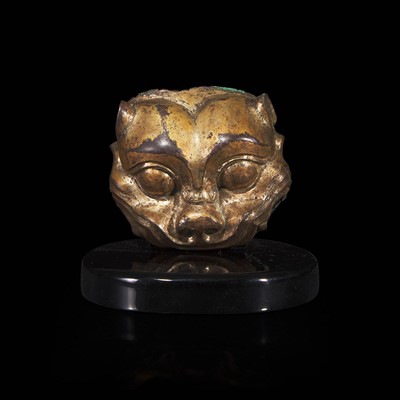 Lot 74 - A Chinese gilded bronze feline head fitting 铜鎏金兽首